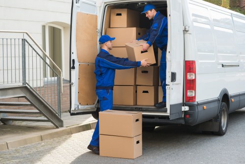 Business relocation team handling office furniture and technology