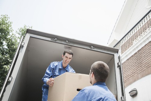A moving team loading boxes into a hire truck in Kentishtown