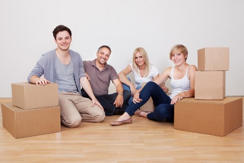Removal team safely handling furniture during a home move