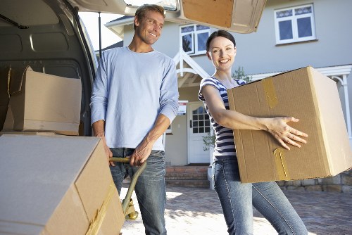 Professional team loading bulky furniture onto a truck